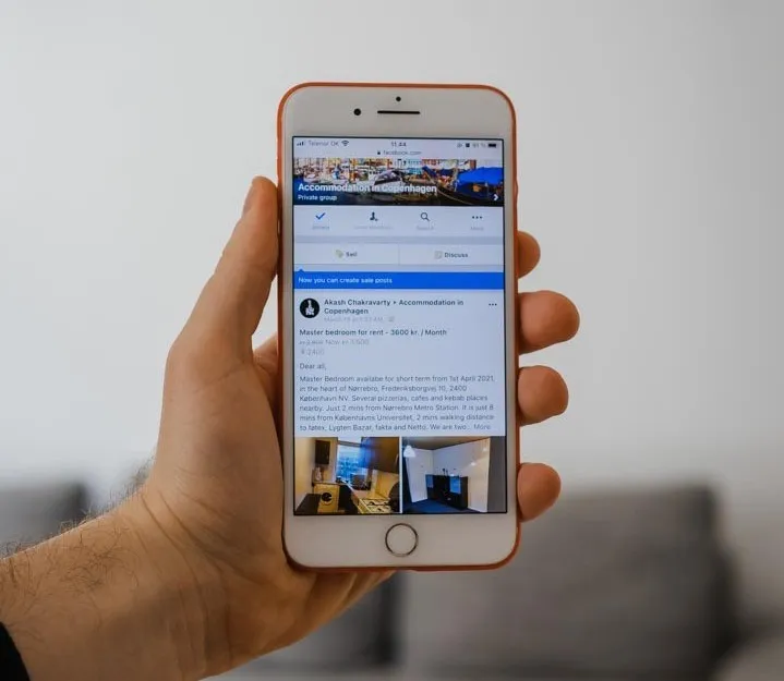 Phone displaying a Facebook group for accommodation in Copenhagen.