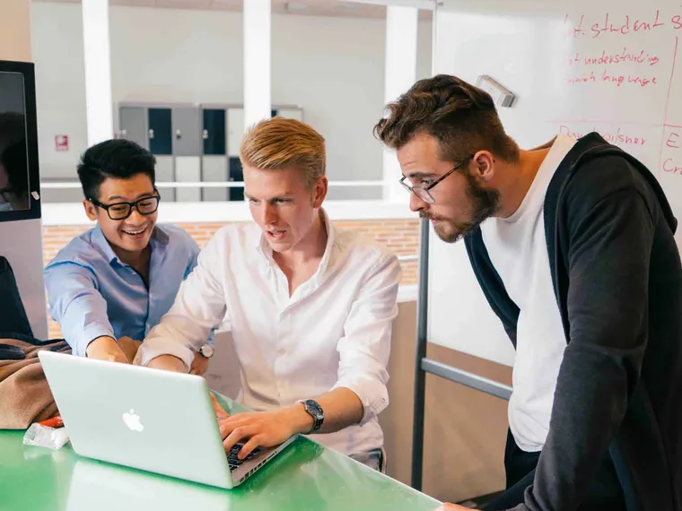 The Student Survival Guide team working together on a laptop